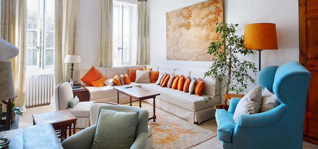 Large Domain Valbonne living room sofa with orange pillows
