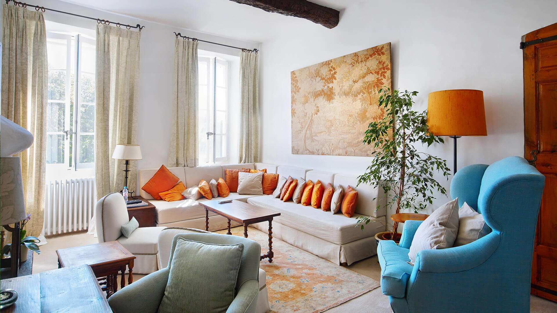 Large Domain Valbonne living room with sofa and orange pillows