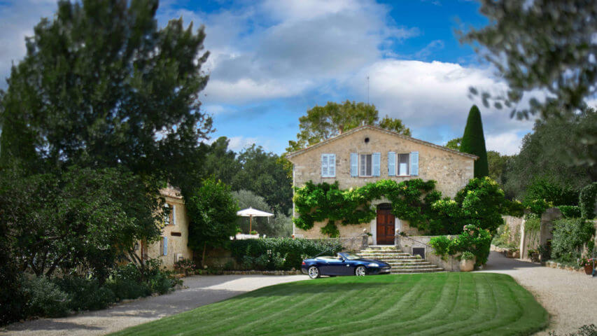 Large Domain Valbonne entrance with trees and a car