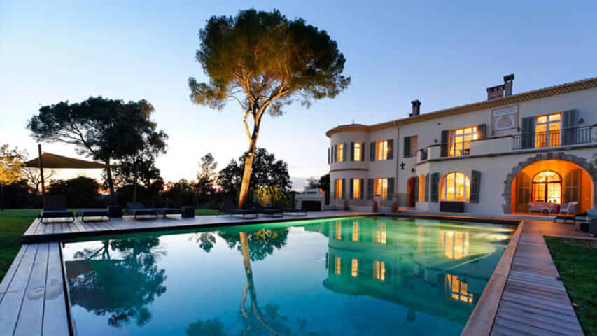 Large luxury Chateau garden and swimming pool at night